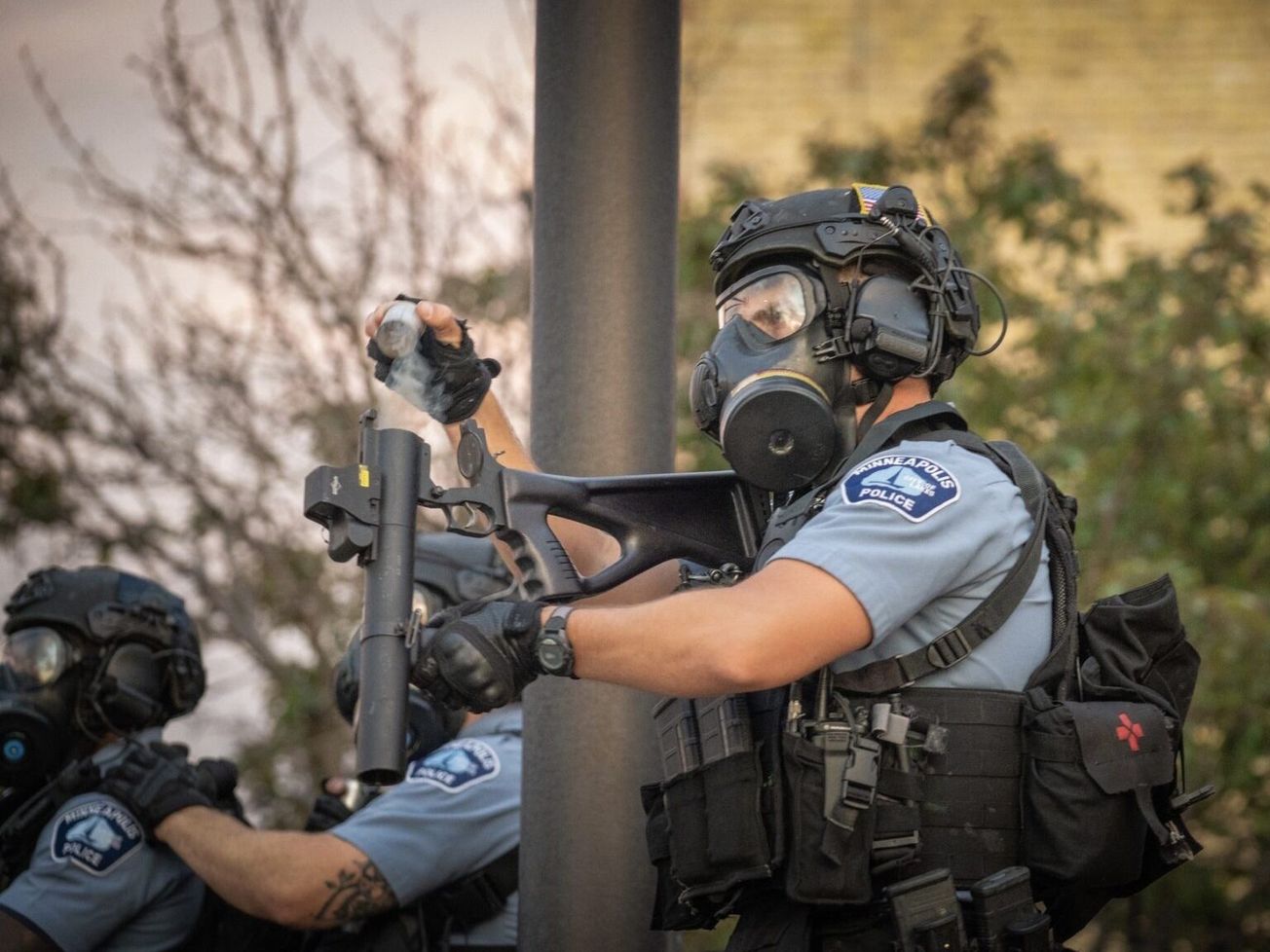 A Minneapolis police officer watching a crowd of protesters in late May