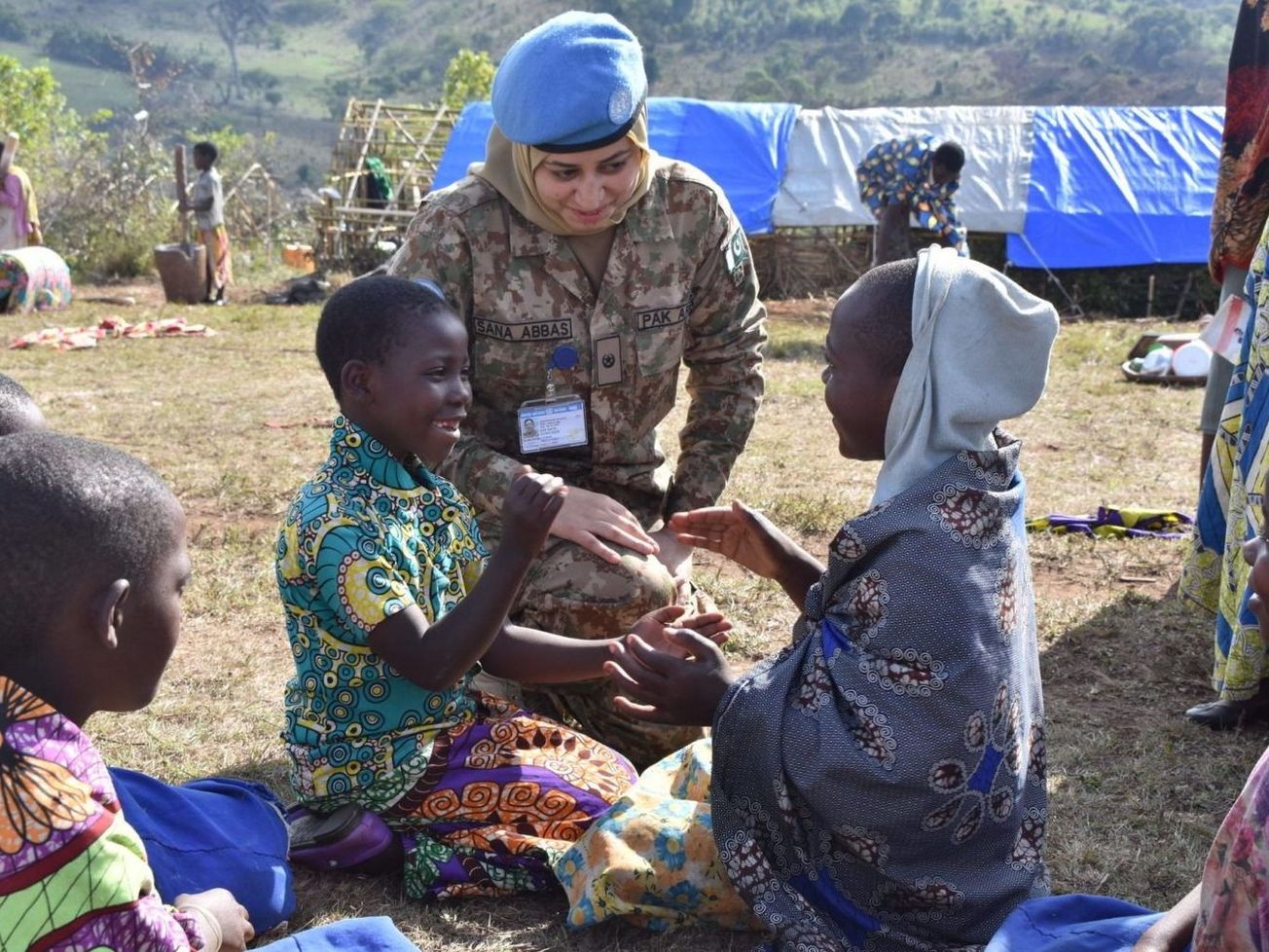A child protection officer from the U.N.'s Pakistani Female Engagement Team comforts children at Mikenge, Congo