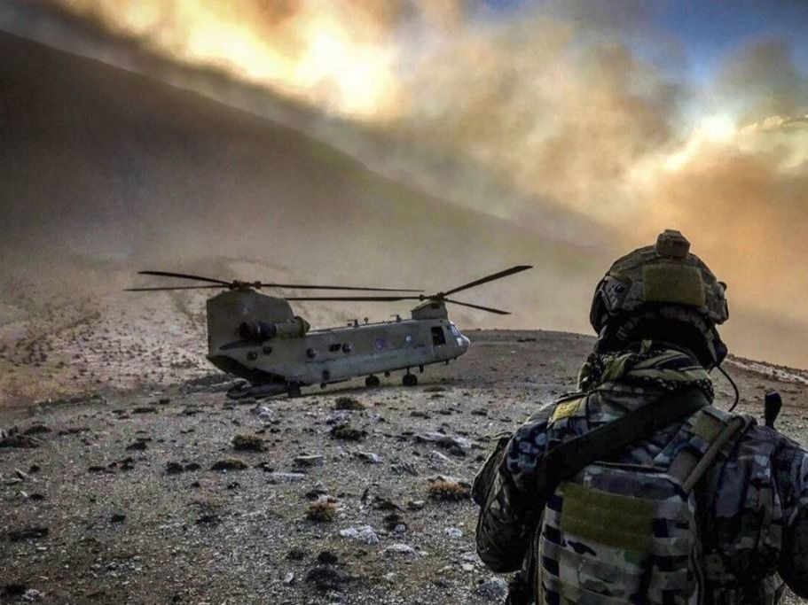 An airman watches a U.S. Army CH-47 Chinook in Afghanistan