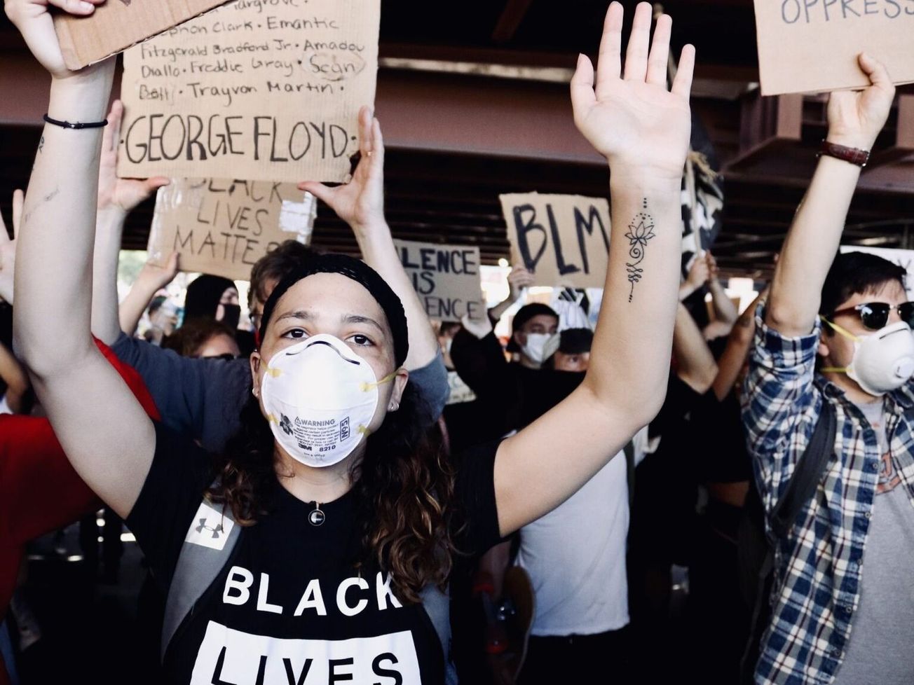Youth-led U.S. demonstrators at Baltimore, Md., raise hands for racial justice in George Floyd's killing