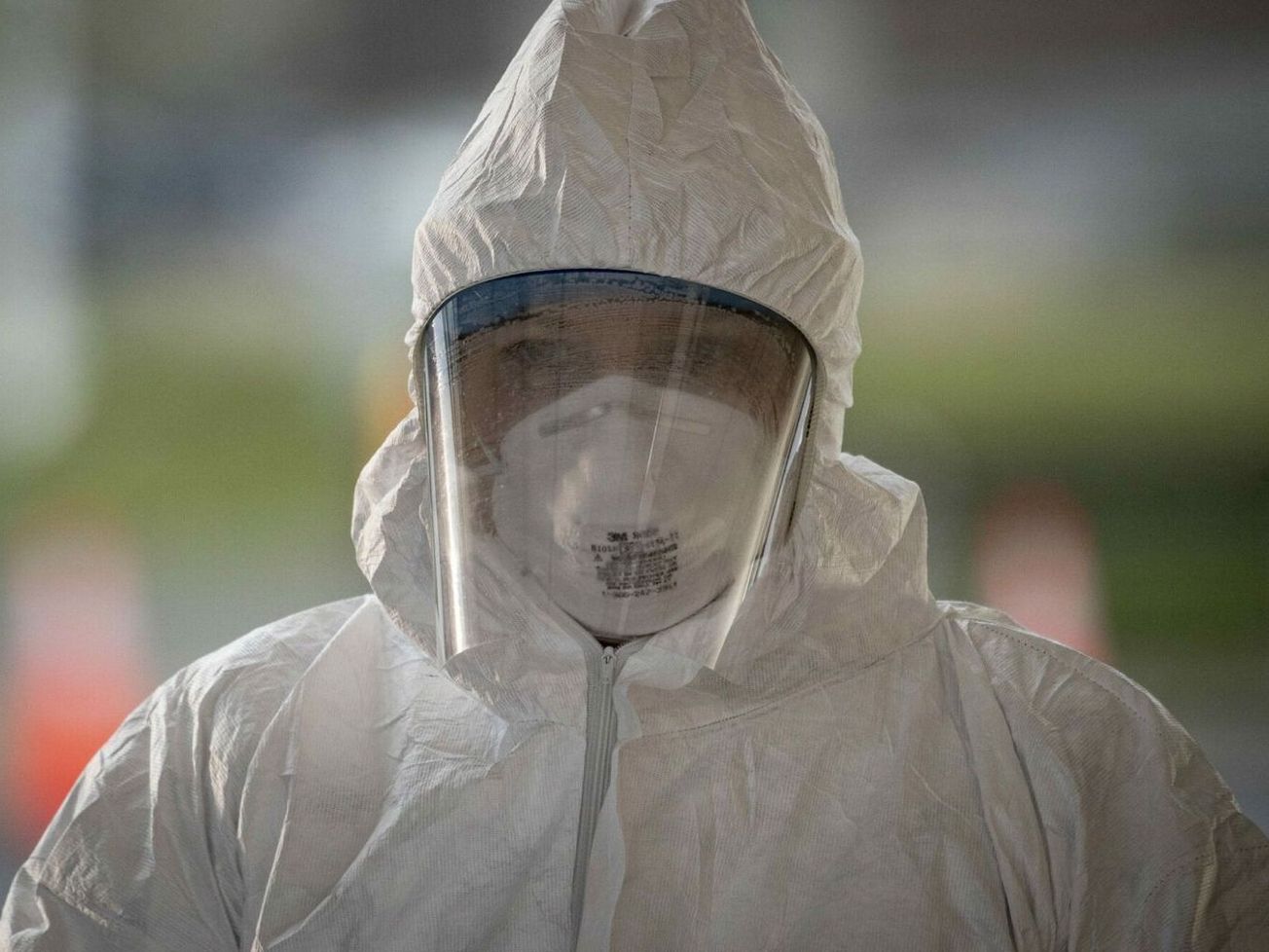 A U.S. medical technician pauses between patients at a COVID-19 testing site in Holmdel, N.J.