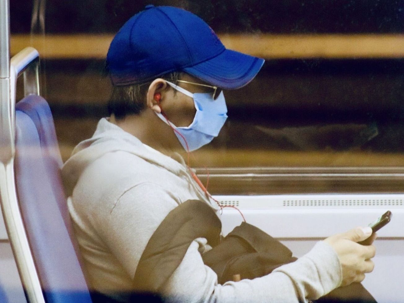 A masked U.S. passenger rides the Metro in the nation's capital