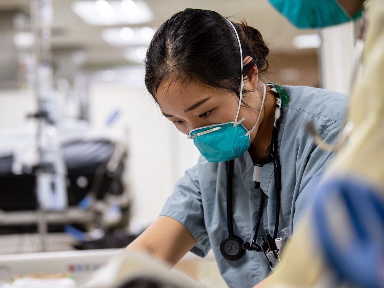 U.S. sailor Joyce Sim treats a patient aboard a hospital ship supporting the nation's COVID-19 response effort
