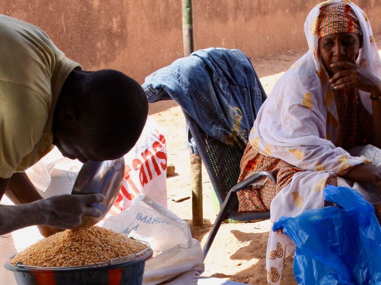 A Malian woman waits at a WFP-organized site in Bamako for food to feed her family of 22