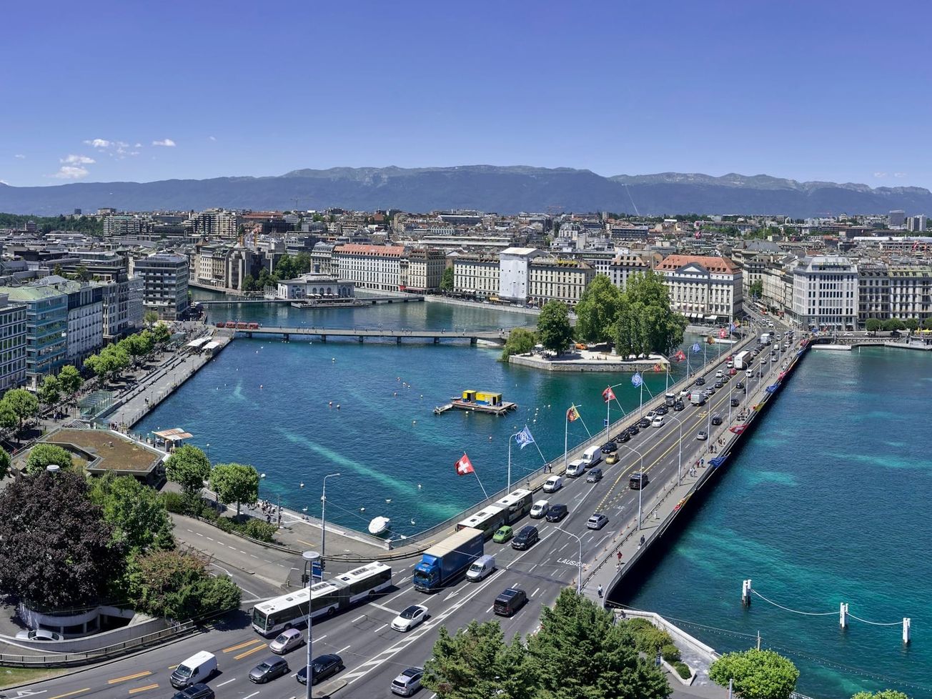 Geneva's Pont du Mont Blanc, the heavily traveled north–south bridge above the Rhône River and Lake Geneva. 