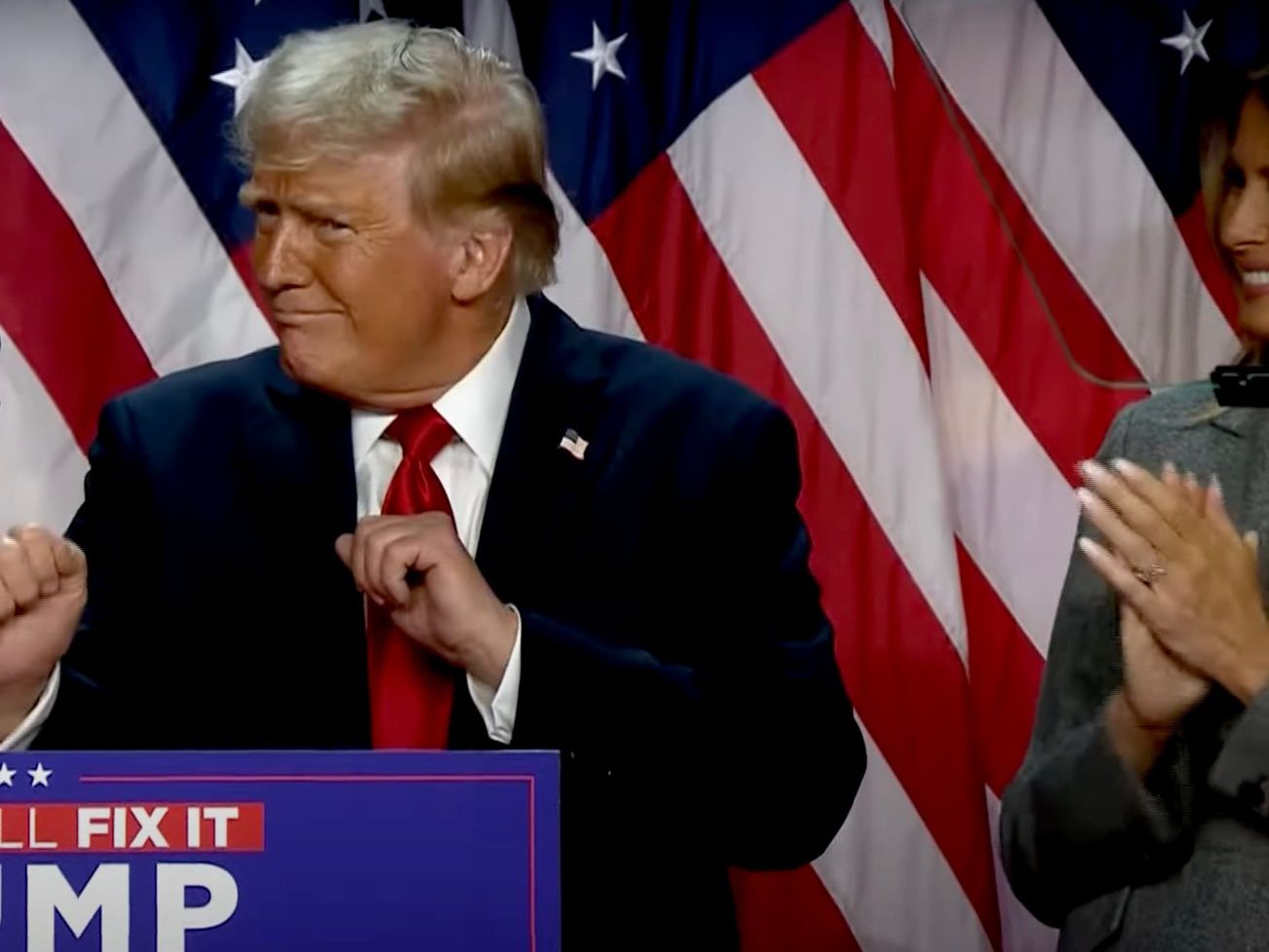 Donald Trump celebrates his victory as his wife Melania looks on.