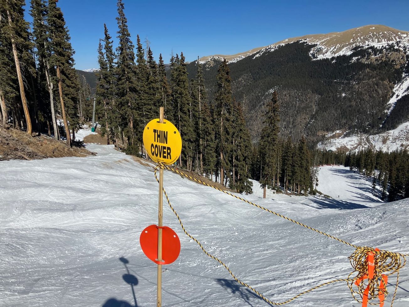 A sign at Taos Ski Valley warns skiers of the low snow coverage.