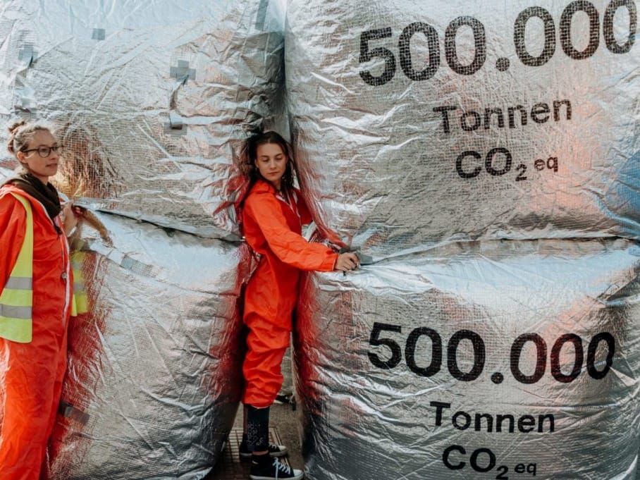 Climate protesters in Vienna with symbolic tons of CO2 emissions