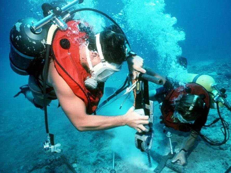 Divers repair an undersea cable at the U.S. Navy's Pacific Missile Range Facility