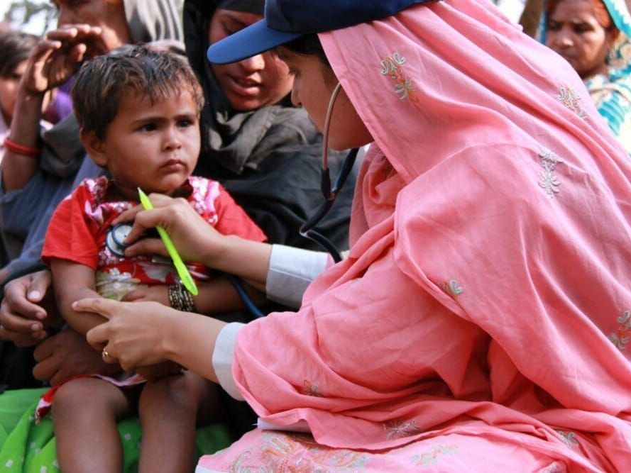 octor with the International Medical Corps examines a boy at a mobile health clinic in Pakistan.