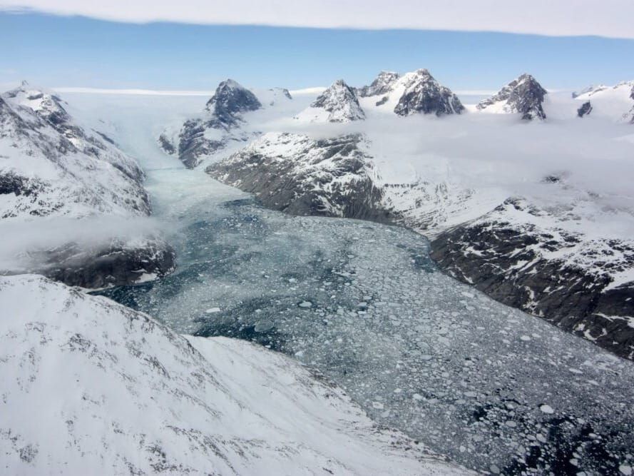 A glacier in eastern Greenland flowing through a fjord carved by the movement of ice.