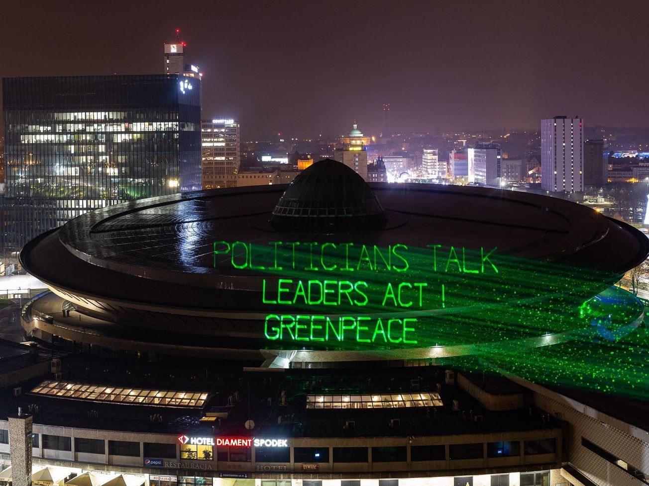 Greenpeace activists display a message for leaders in Poland.