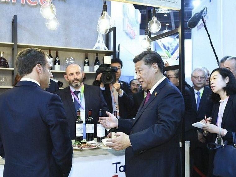 French President Emmanuel Macron and Chinese President Xi Jinping talk in Shanghai while sampling French wine and beef