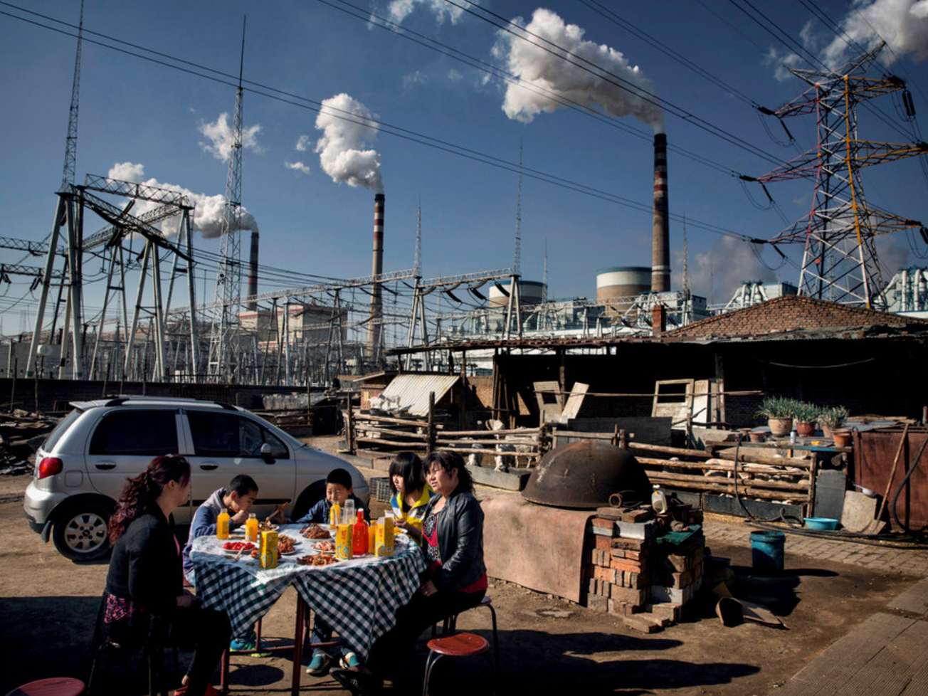 A family of migrant construction workers in their housing compound by a coal-fired power plant in Datong, China