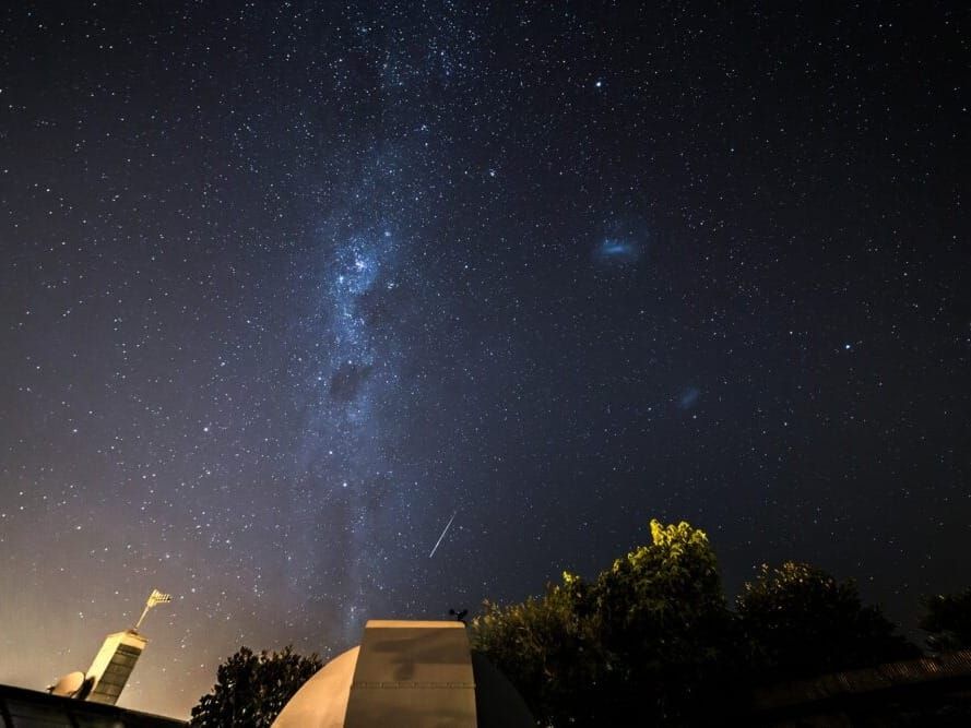 The Milky Way and Magellanic clouds above a New Zealand observatory