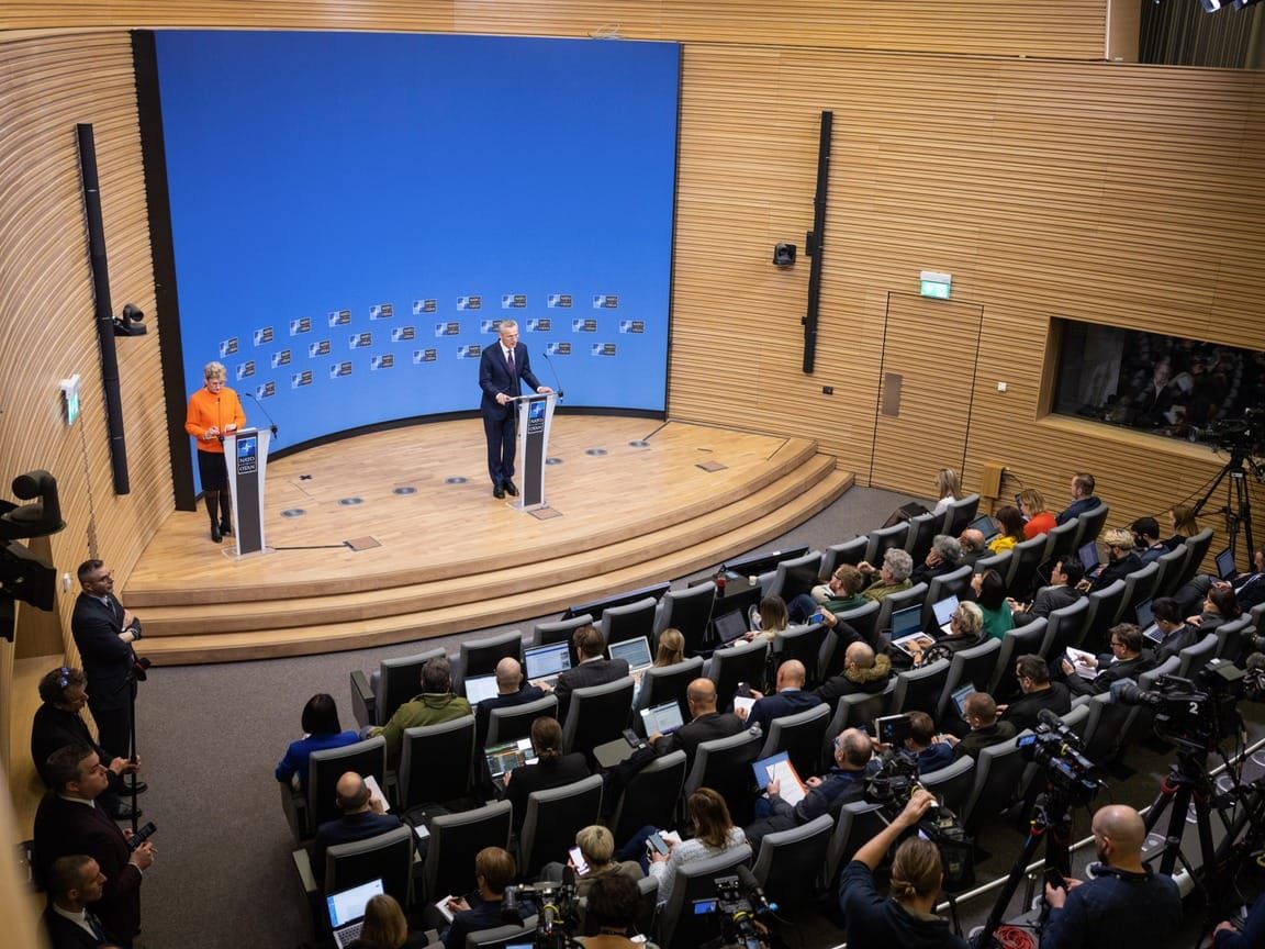 NATO's spokesperson Oana Lungescu, left, and secretary general Jens Stoltenberg, right, at a press conference in Brussels