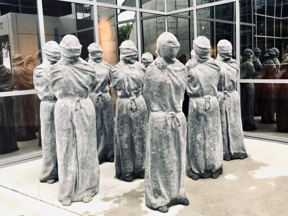 Eight stone carvings of prisoners greet visitors to the museum at the ICRC in Geneva.