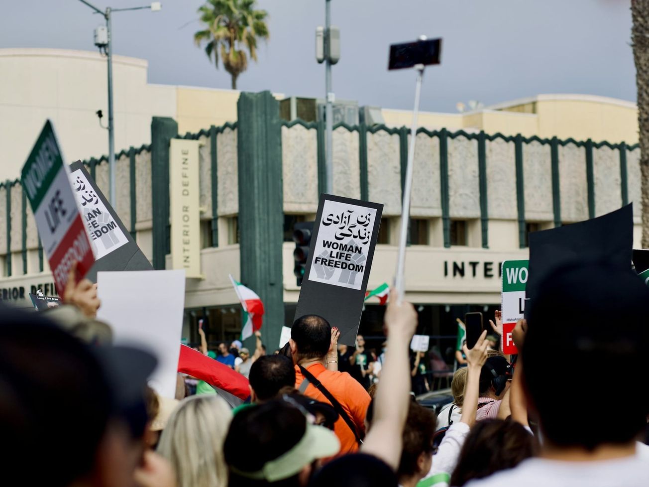 Demonstrators hold signs calling for women's rights in Iran