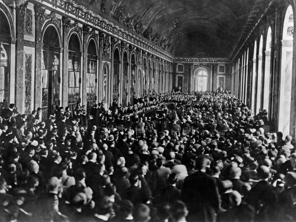 The treaty signing on June 28, 1919 in the Palace of Versailles' Hall of Mirrors.