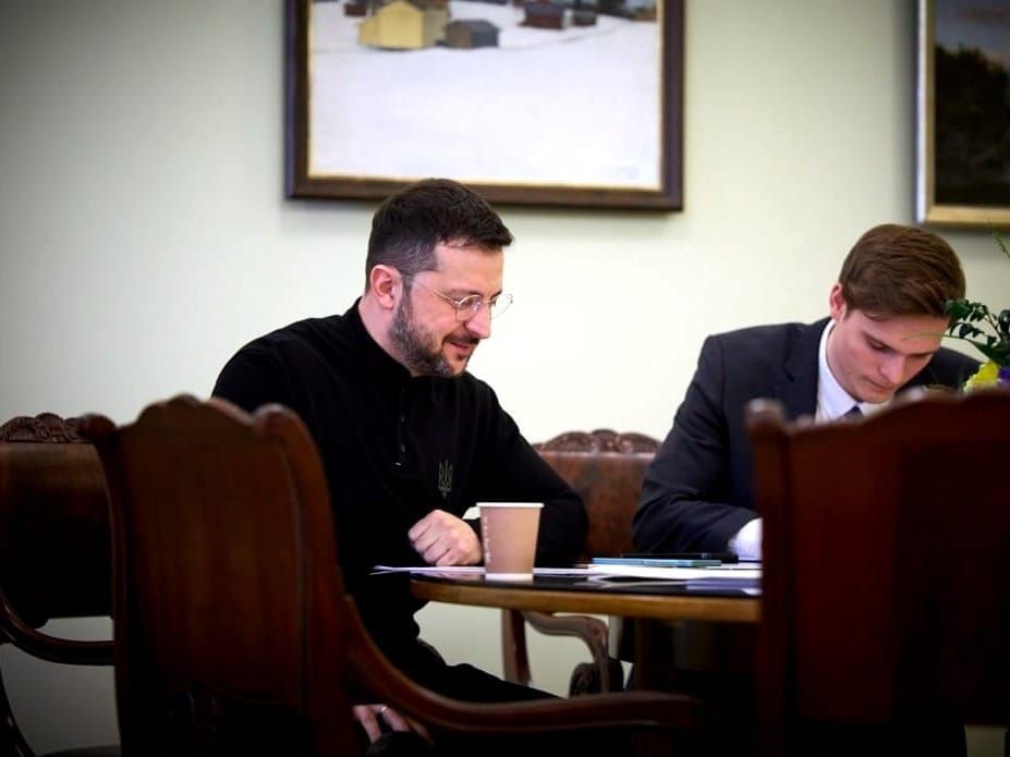 Ukrainian President Volodymyr Zelenskyy at work with an aide.