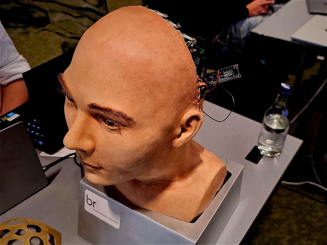 A humanoid robot's head greets visitors at the Hanson Robotics booth during the International Telecommunication Union's 2024 AI for Good Global Summit in Geneva. 