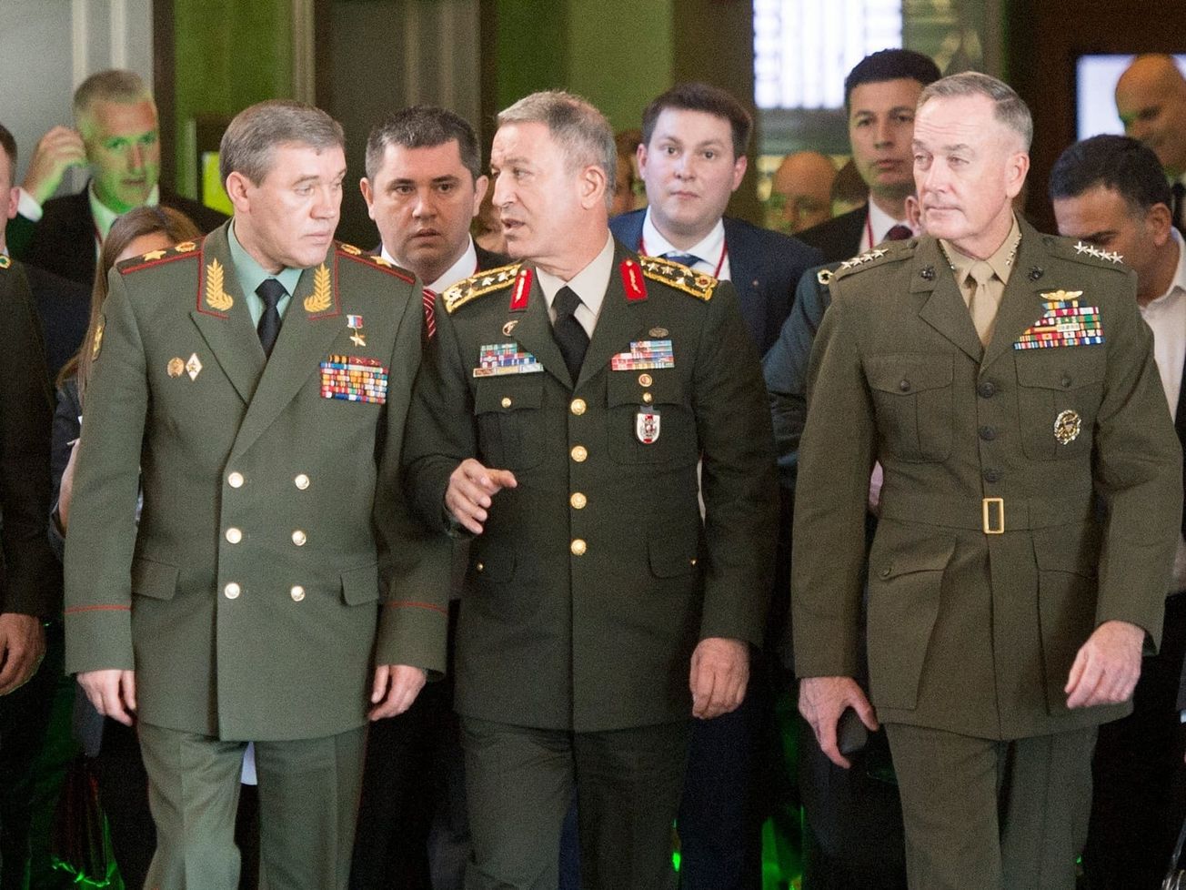 Gen. Valery Gerasimov of the Russian army, left, speaks with his Turkish and U.S. counterparts