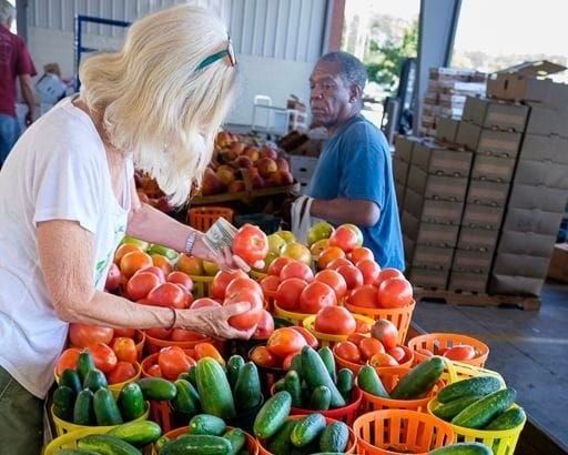Farmers sell their fresh-picked vegetables at community market