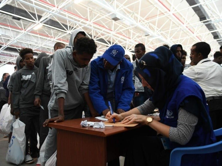 Officers from U.N. Migration, or IOM, enroll Somalis returning from Libya.
