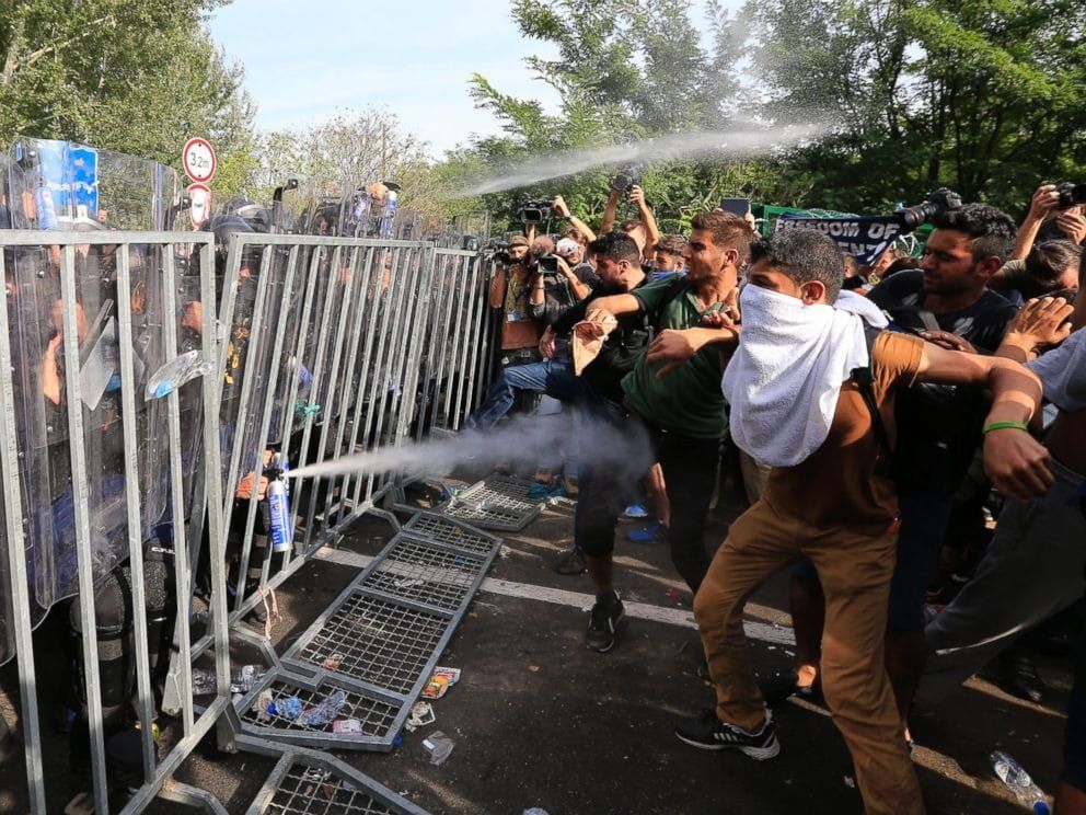 Confrontation between migrants and police at Hungarian border. 