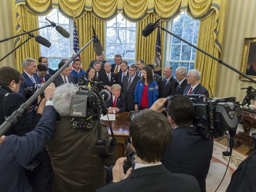 U.S. President Donald Trump talks with press in the Oval Office.