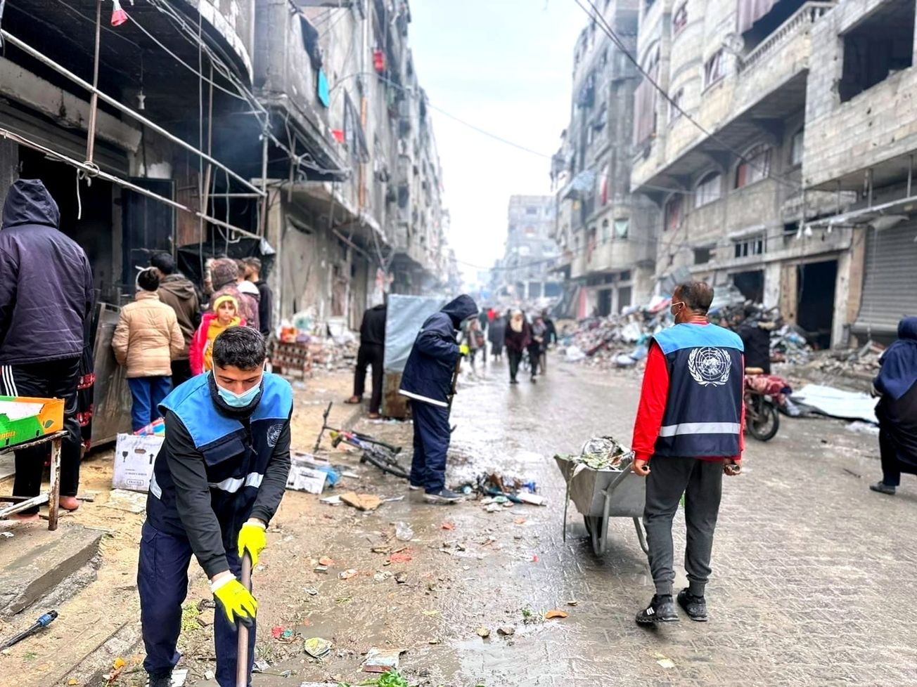 Humanitarian aid workers help clean up the streets in Gaza.