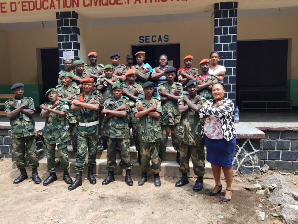 Congo officers fold their arms as part of a U.N. initiative to "Stop Rape Now" as a tactic of war.