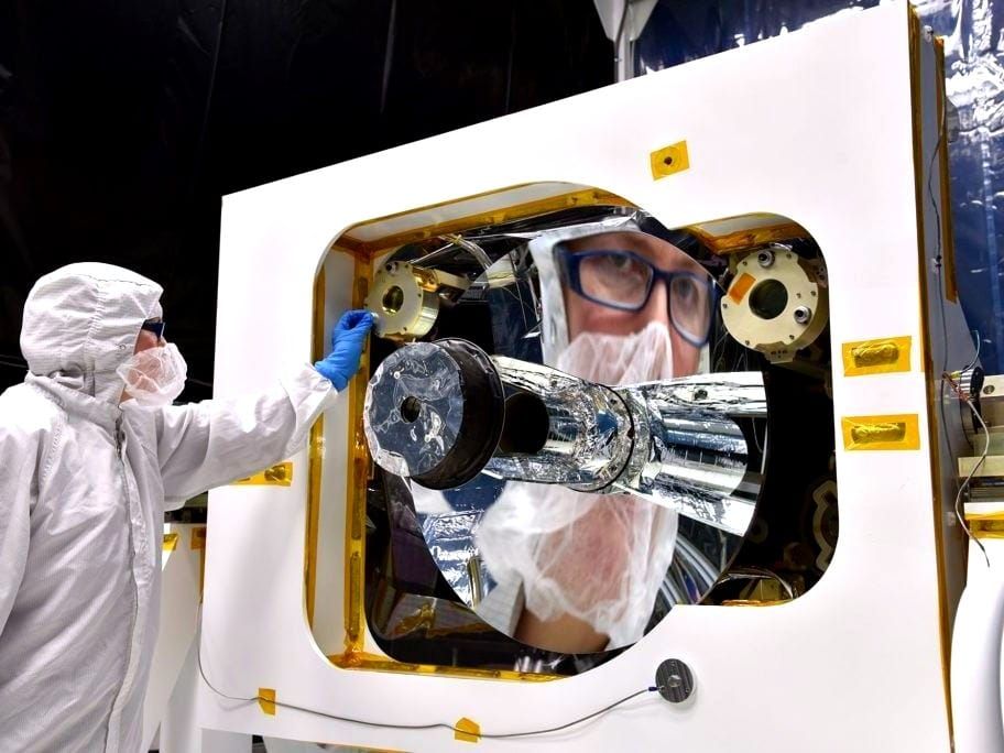 NASA engineer Bente Eegholm prepares a new laser instrument, GEDI