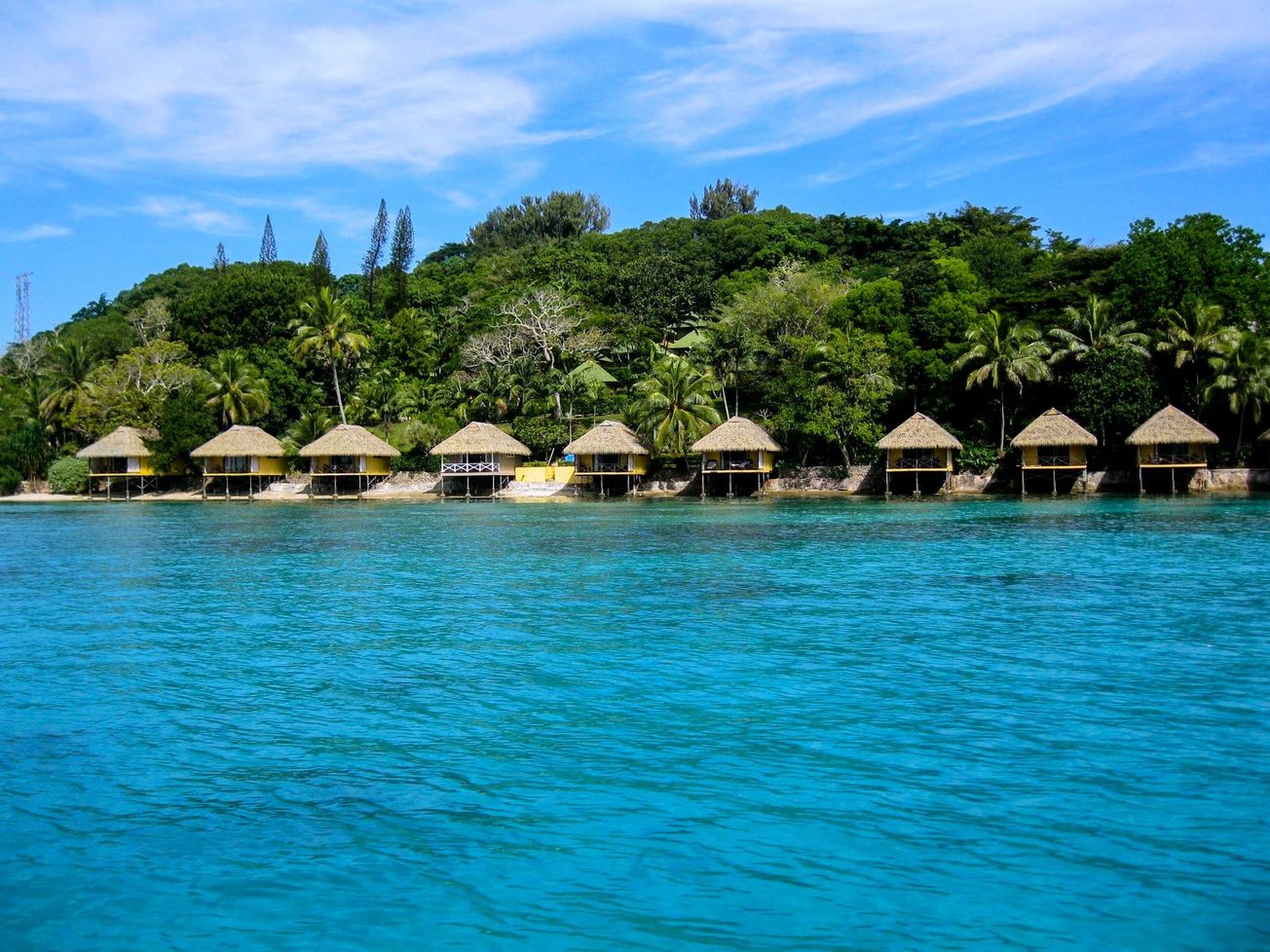 Vacation homes line the coast of an island resort in Vanuatu.