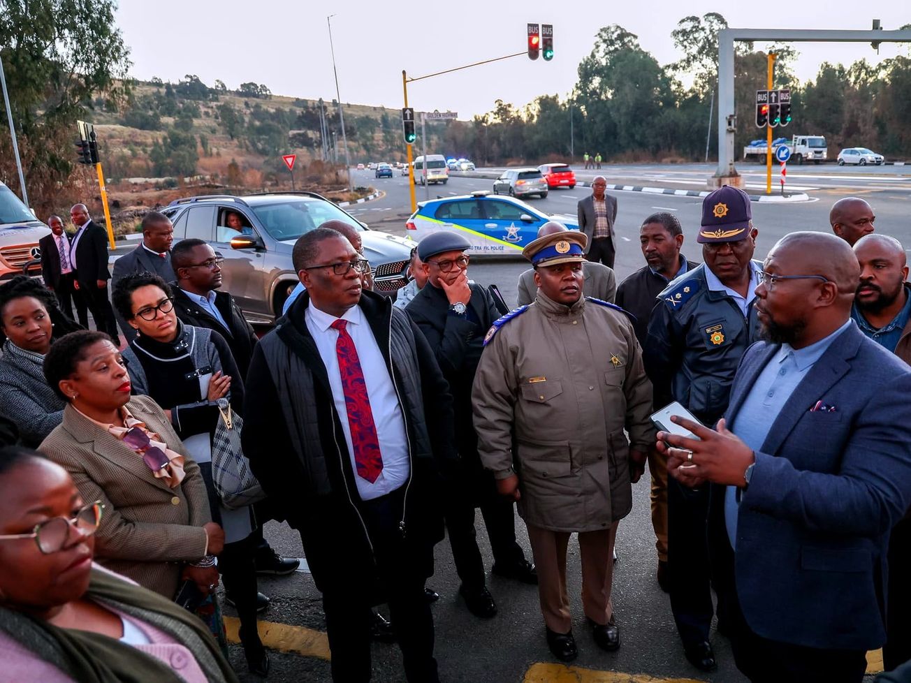 Panyaza Lesufi, Premier of South Africa's Gauteng Province, at right, briefs South Africa's Minister of the Presidency Khumbudzo Ntshavheni, at left, and other officials.