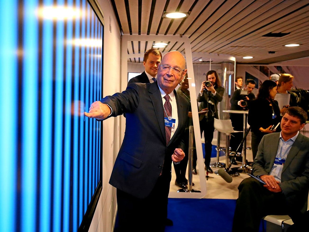 WEF founder Klaus Schwab draws a crowd. 