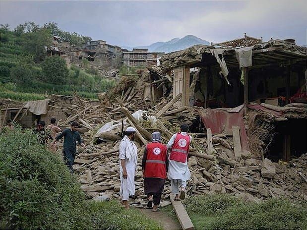 Afghan Red Crescent volunteers and local residents search for survivors and provide first aid. 