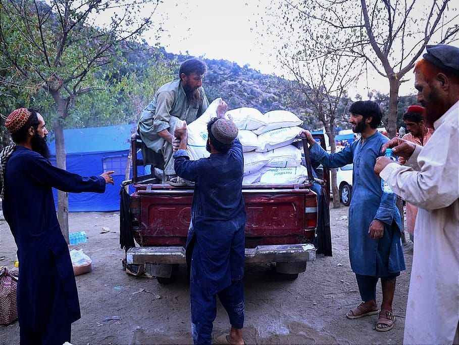 Aid workers deliver food to people affected by the earthquake in eastern Afghanistan.