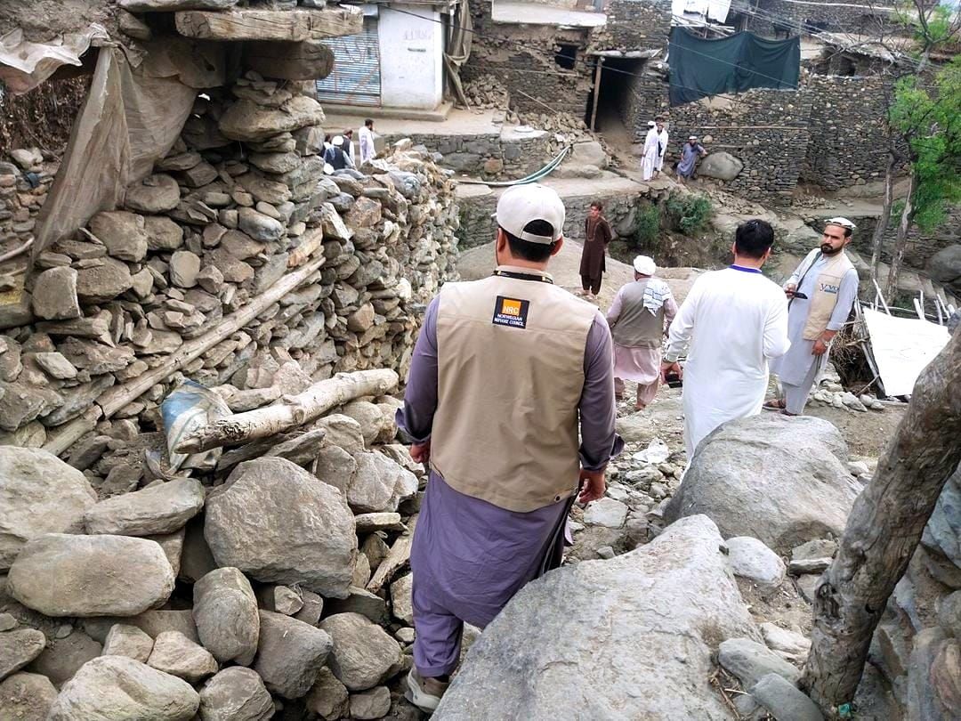 A Norwegian Refugee Council aid worker surveys the Afghan quake damage. 