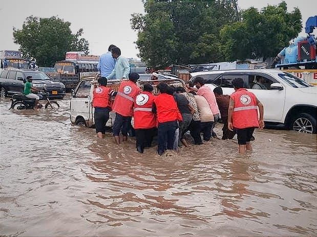 Pakistan Red Crescent volunteers help people stranded by heavy flooding.