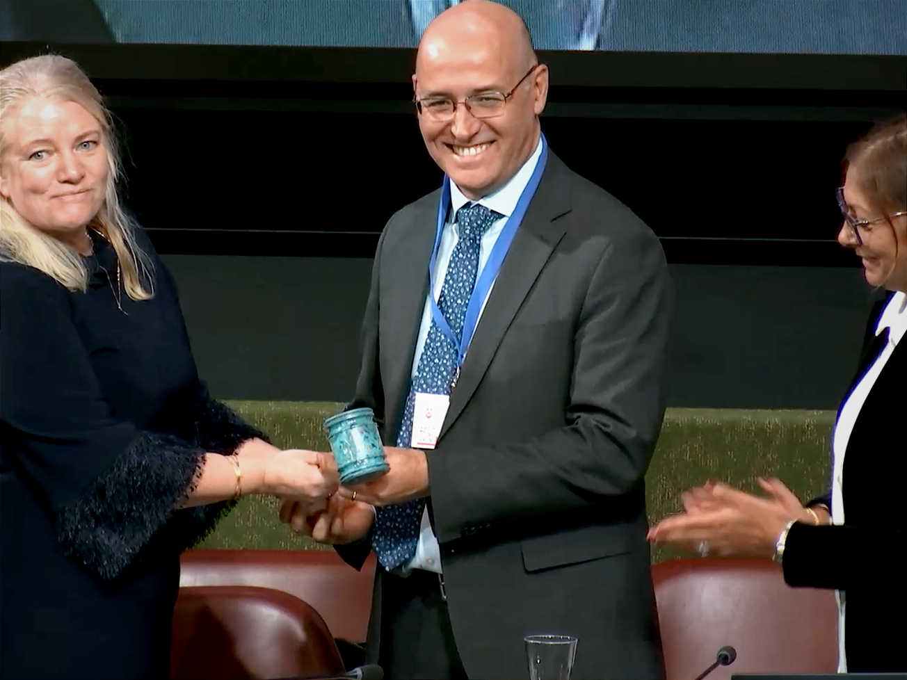Julio Cordano, a diplomat from Chile, accepts the gavel as newly elected chair of the U.N.'s Intergovernmental Negotiating Committee on Plastic Pollution.