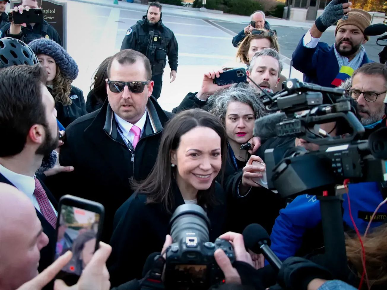 Venezuelan opposition leader María Corina Machado speaks with reporters after greeting supporters near the White House, where she met with U.S. President Donald Trump.