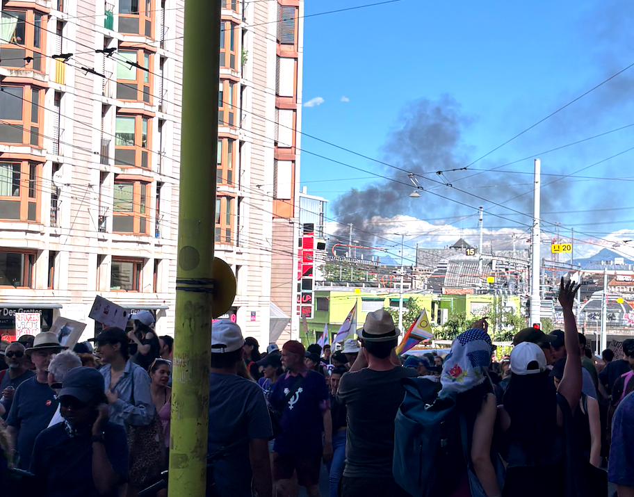 A plume of tear gas is seen rising above the Geneva train station.