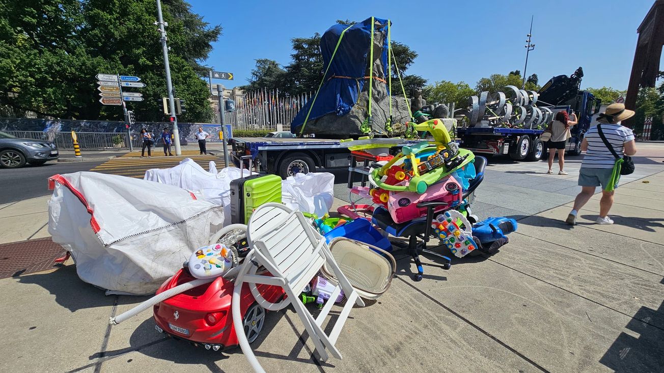 A truck prepares to remove Benjamin Von Wong’s The Thinker’s Burden, an art installation surrounded by plastic trash.
