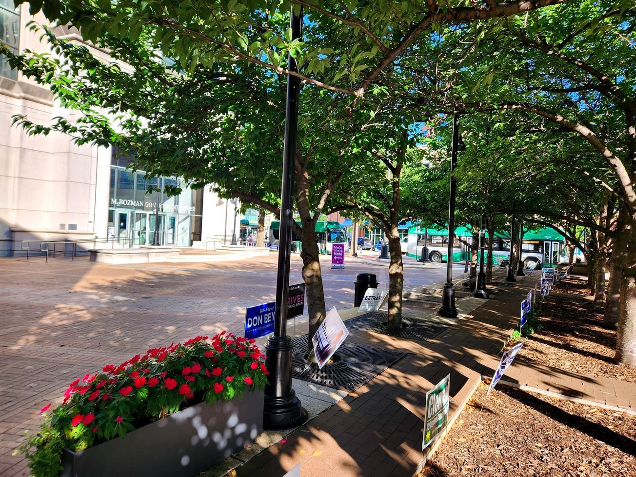 Display signs set up in approved places greet visitors outside the Arlington County Courthouse in Virginia ahead of the 2026 U.S. midterm elections.