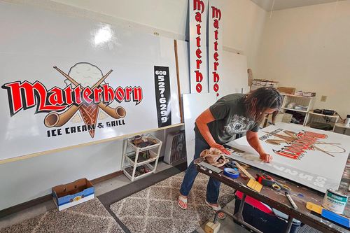 The Sign Painter Behind a Piece of New Glarus