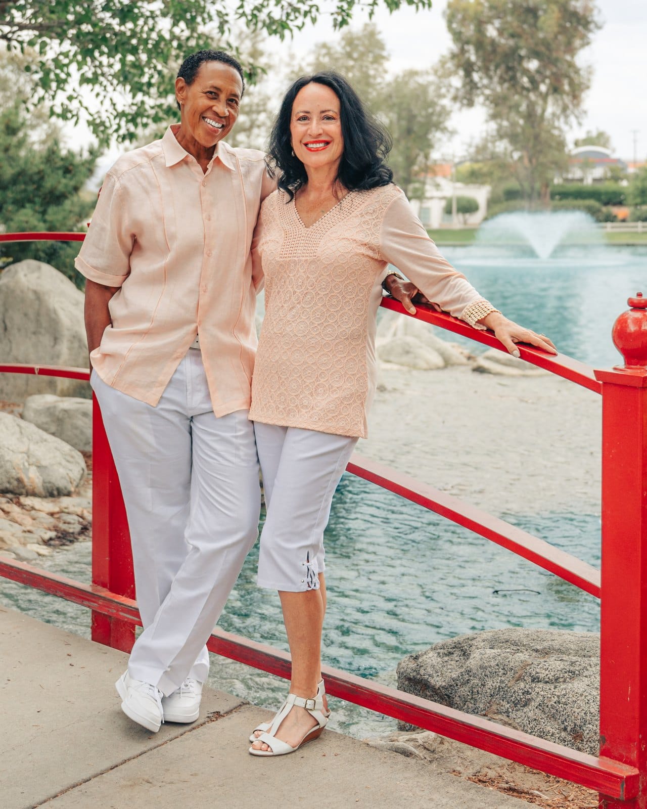 Jill and Lori, the wedding officiants and premarital mentors behind Jillori, together on a bridge
