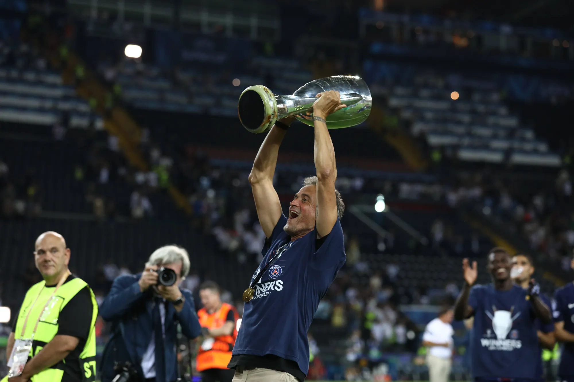 Luis Enrique celebrates PSG's UEFA Super victory by lifting the trophy