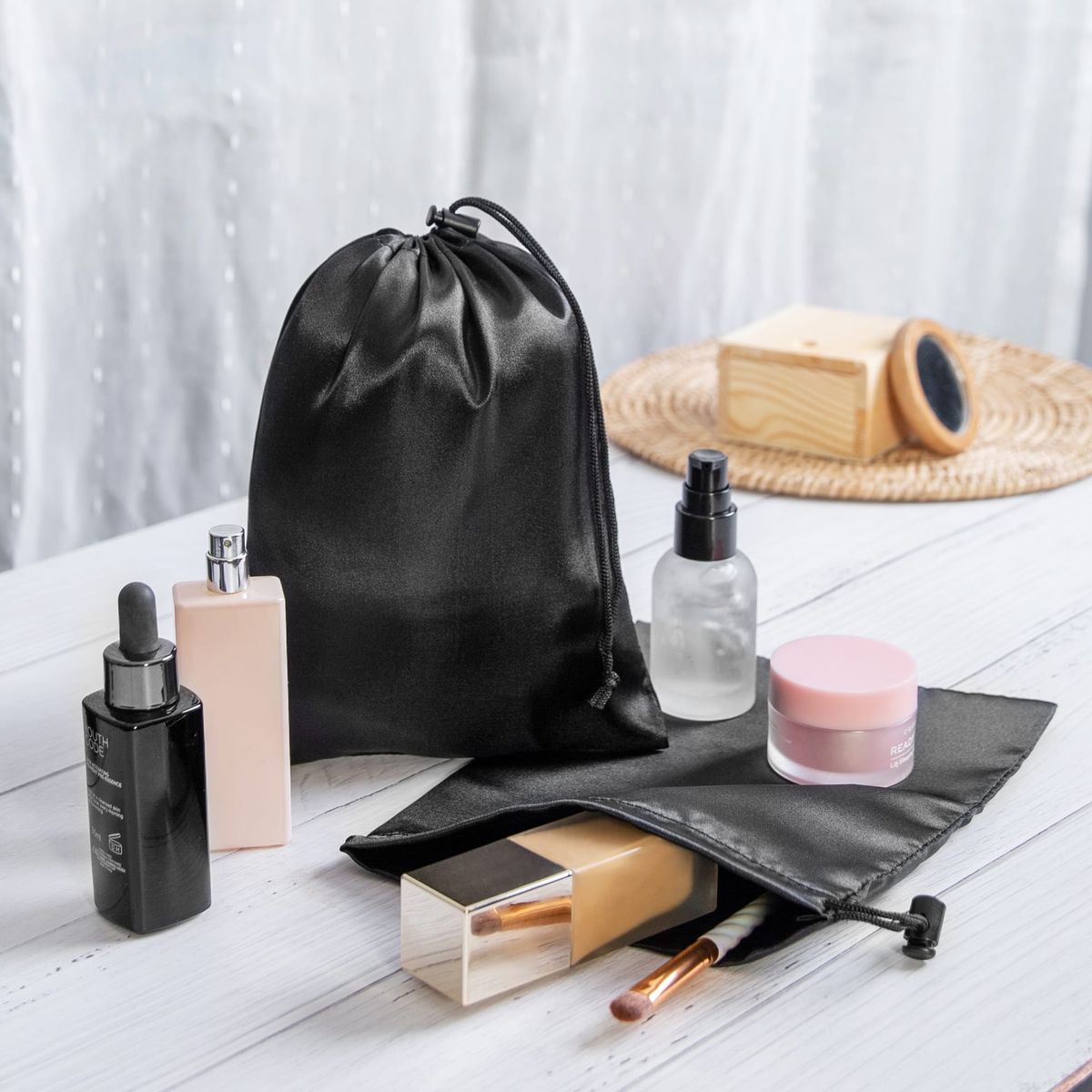 Various items organized in a black drawstring bag