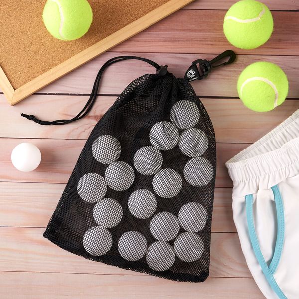 A mesh bag filled with ping-pong balls on a wooden table